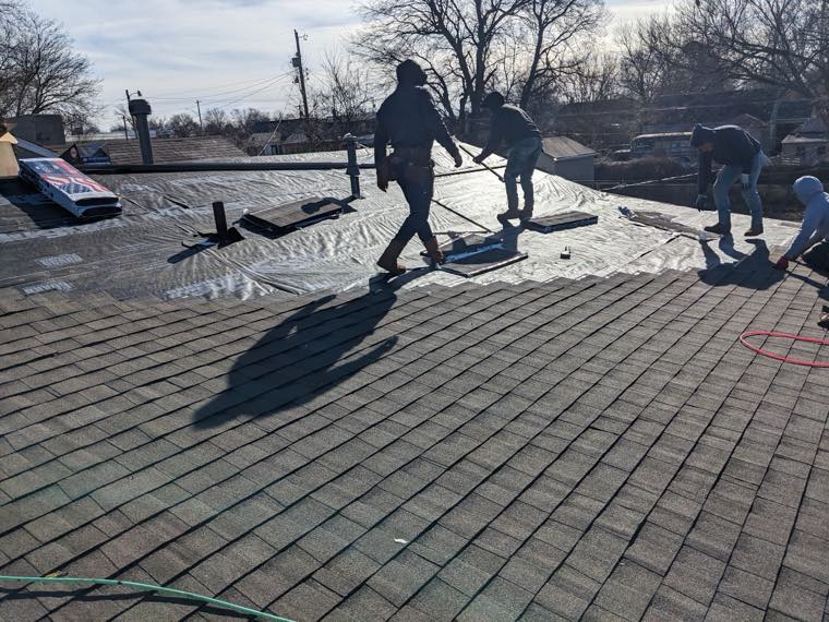 Tedder’s Roofing LLC crew installing shingles